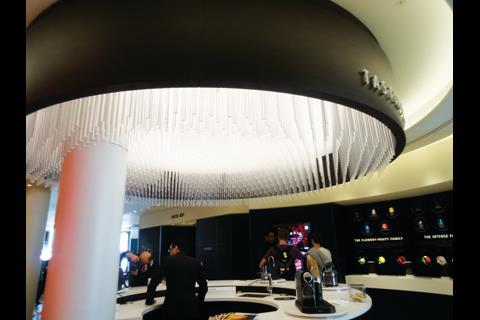 Perspex rods descend from the canopy above the tasting area, while a series of low mid-shop units provides display space for accessories